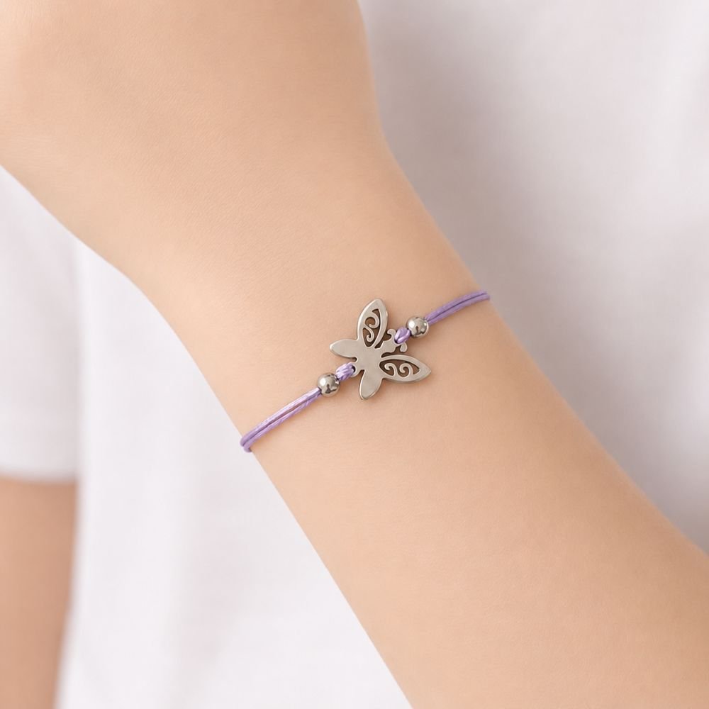 Bracelet enfant papillon Pina Minia en acier inoxydable argenté avec cordon violet ajustable.