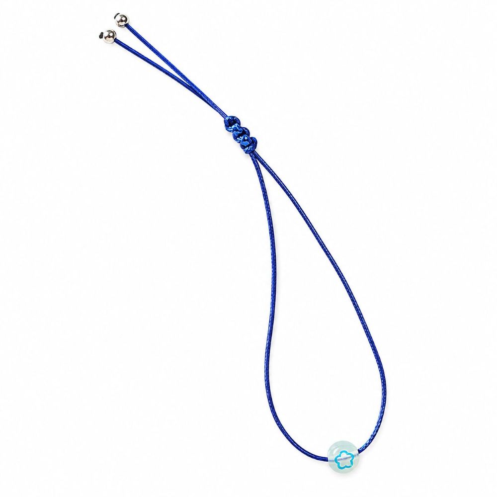 Bracelet enfant Fleur Lumineuse Faria Minia en acier inoxydable avec fleur phosphorescente et cordon ajustable.