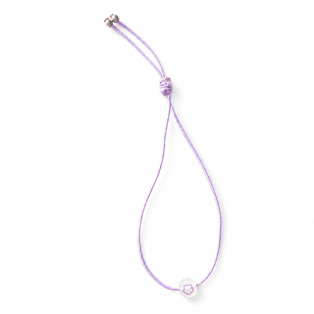 Bracelet enfant Fleur Lumineuse Faria Minia en acier inoxydable avec fleur phosphorescente et cordon ajustable.