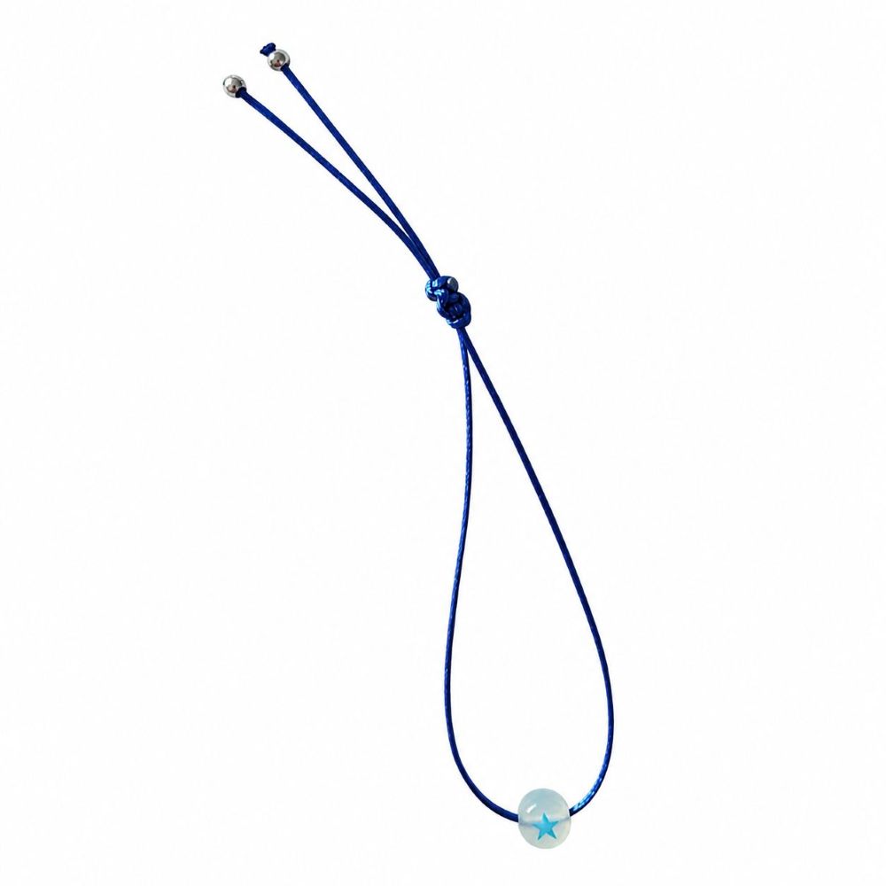 Bracelet enfant Étoile Lumineuse Eliza Minia en acier inoxydable avec étoile phosphorescente et cordon ajustable.