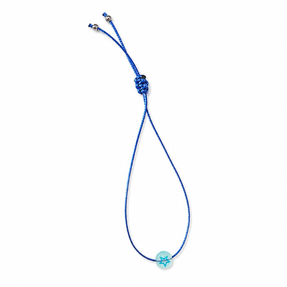 Bracelet enfant Étoile Lumineuse Eva Minia en acier inoxydable avec étoile phosphorescente et cordon ajustable.