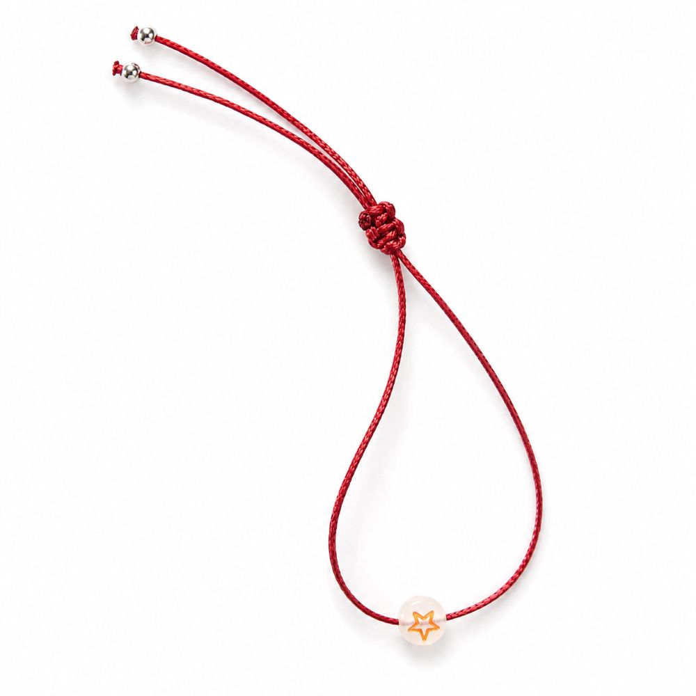 Bracelet enfant Étoile Lumineuse Eva Minia en acier inoxydable avec étoile phosphorescente et cordon ajustable.